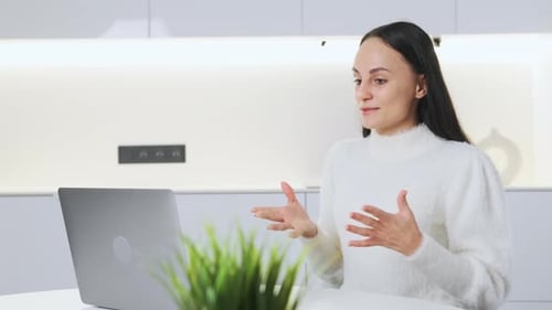 Woman Attending an Online Meeting With Laptop
