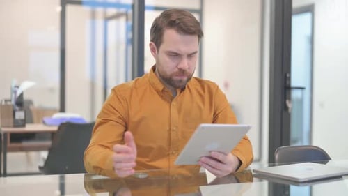Bearded Man Gets Frustrated Using Tablet in Office