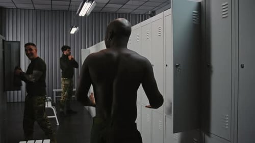 Military Shift Change Soldiers Swapping Gear and Dressing in Base Locker Room Before Duty
