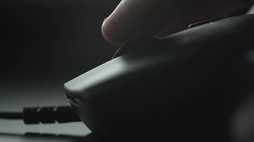 Finger scrolling up with a black mouse wheel