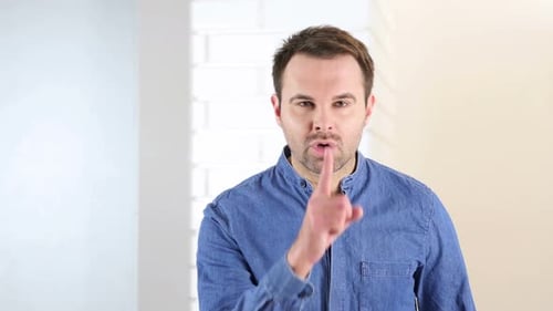 Silence Gesture By Middle Aged Man