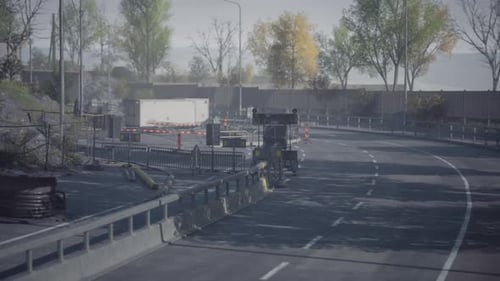Road Construction Near a Highway Surrounded By Autumn Foliage and Stillness