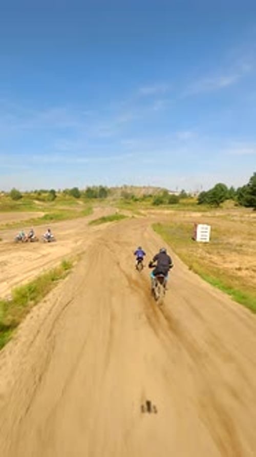 People Riding Motocross Bikes on a Rural Dirt Track