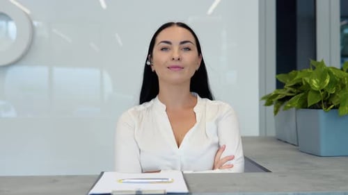 Smiling Receptionist at Modern Office Reception Desk