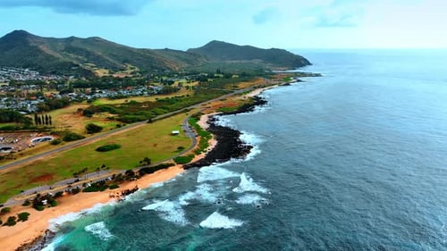 Beautiful sandy beach with some black stones at the shore.