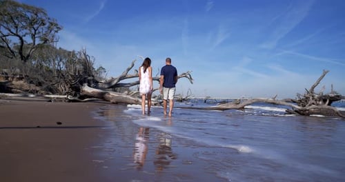 Aerial, Couple Walking Waves on Romantic Florida Beach Sunset Adventure