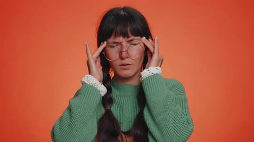 Young Woman Suffering from Headache, Rubbing Temples