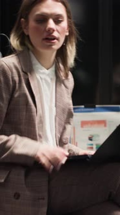 Business Woman Discussing Graphs in Modern Office