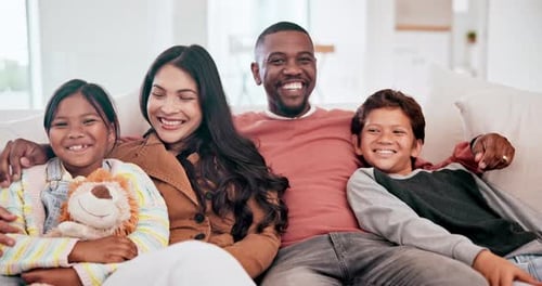 Happy Family Relaxing Together on Sofa at Home