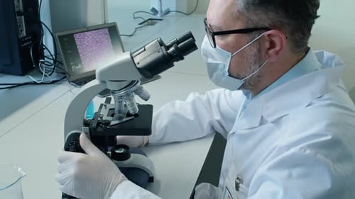 Scientist Using Microscope in Bright Laboratory
