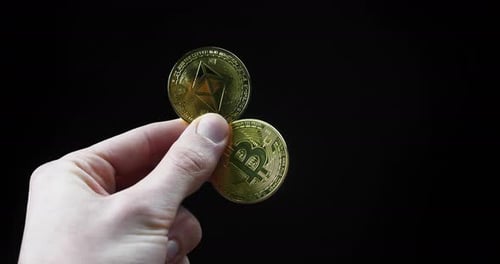 hand holding golden coins etc bitcoin and etc etheruem on black studio background concept of crypto