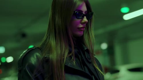 Stylish Woman Posing with Sunglasses in Neon Lights