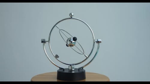 Kinetic Sculpture with Rotating Spheres on Table