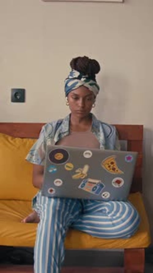 Young Adult Working on Laptop at Home