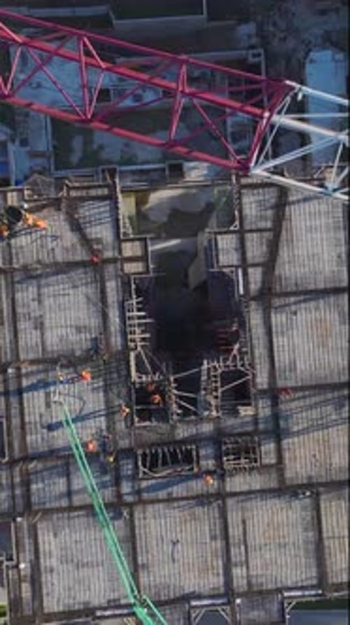 Vertical Video of a Construction Site at Sunset Captured From a Drone With Shadows Stretching Over