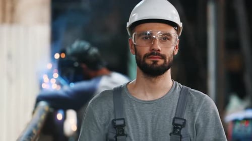 Portrait of a professional heavy industry engineer. Worker wearing protective uniform, goggles and h