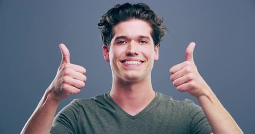 Young Adult Gives Two Thumbs Up Approval