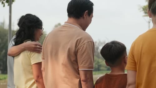 Joyous Asian Family on Walk in Park