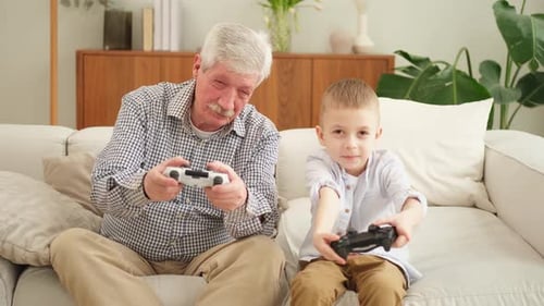 Grandfather and Grandson Playing Video Games Together