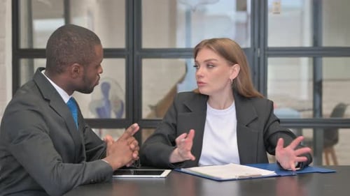 Business People Discussing Documents at Work