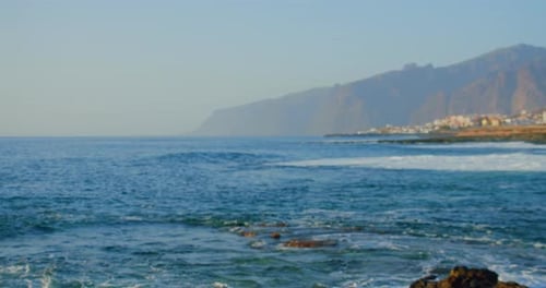 Drone Flies Above Blue Ocean Coastline