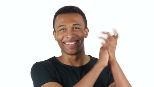 Smiling Young Man Clapping Hands in Appreciation