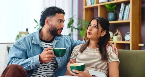 Smiling Couple Relaxing Together at Home with Coffee