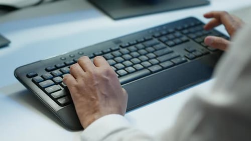 Close Up of Expert Typing on Keyboard in Server Room Coding on Computer