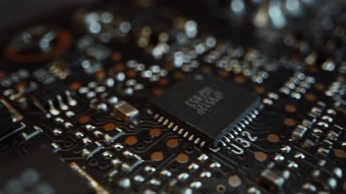 Macro Camera Moving Slowly over Printed Circuit Board, showing Computer Motherboard Components: Mic