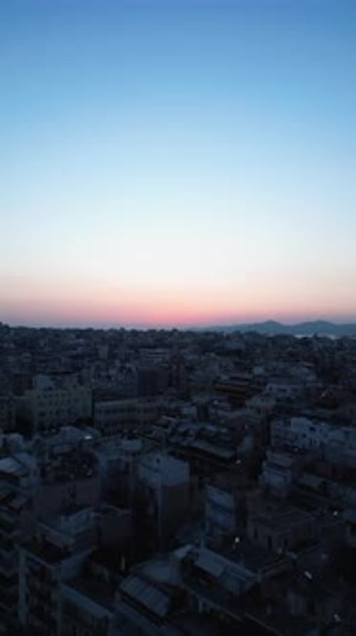 Aerial video flying over urban scenes of Athens during sunset