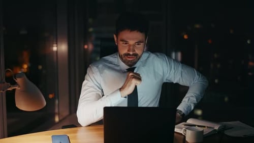 Successful Businessman Working Late Evening in Modern Office Alone Close Up