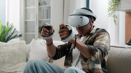 Man Playing VR Game with Headset and Controllers