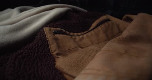 Brown Coat Jacket With Unzipped Pocket. close up, slider
