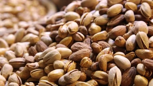 Close up of pistachios gyrating in loop 4K