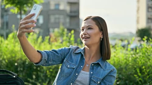 Young Beautiful Woman Having Video Call Chat on Smartphone Outdoor City Background