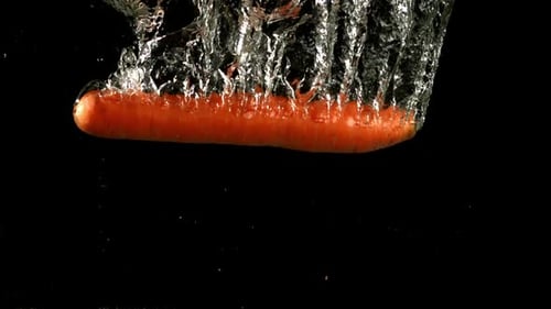 Carrot Falls Under Water Filmed is Slow Motion 1000 Fps