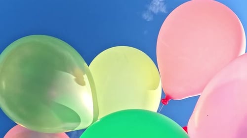 Bright Balloons Floating in a Clear Blue Sky
