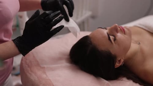 Woman Receives Facial Treatment in Medical Clinic