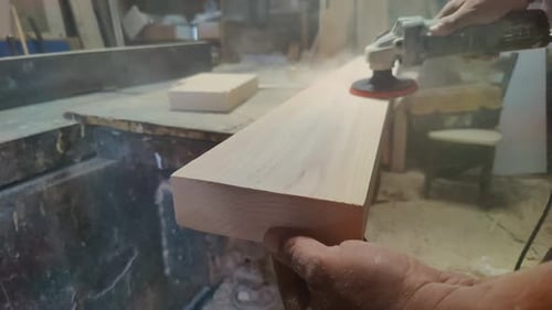 Sanding Smooth Wood Planks In Carpentry Workshop