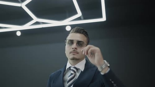 Confident Businessman Posing Proudly in a Modern Office Space