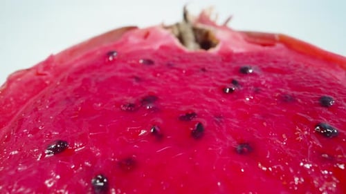 Half a red pitahaya, dragon fruit, seeds. Dolly slider extreme close-up. Laowa Probe