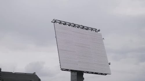 Rotating Radar Antenna Against Cloudy Overcast Sky