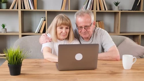 Senior Couple Using Laptop Together at Home
