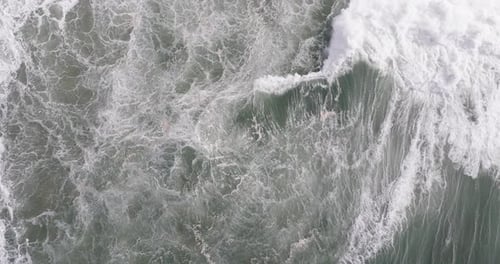 Aerial drone shot of big Atlantic ocean waves coming into shore on a day with giant waves in
