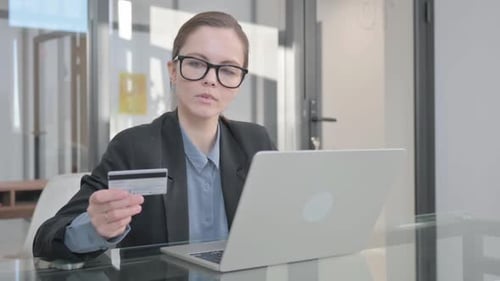 Woman Shops Online with Credit Card in Office