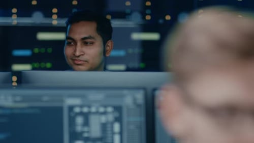 Portraits of Two IT Specialists Working on Personal Computers with Sophisticated Software In Techno