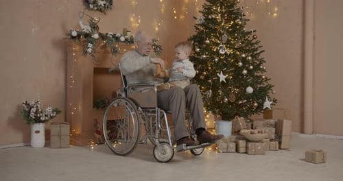 Senior Man with Toddler at Christmas