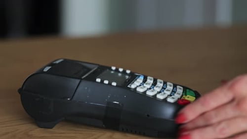 Hands Using Card Reader to Complete Payment