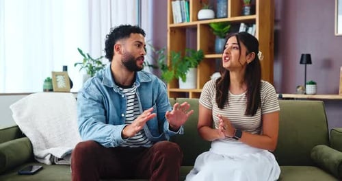 Young Couple Arguing on a Couch in Living Room