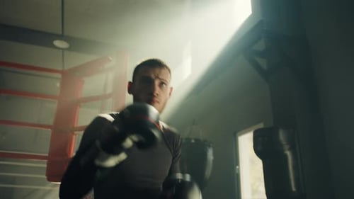 Young Adult Man Boxing at the Gym